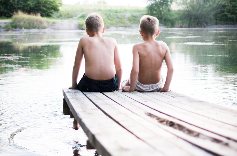 boys on a dock at the lake