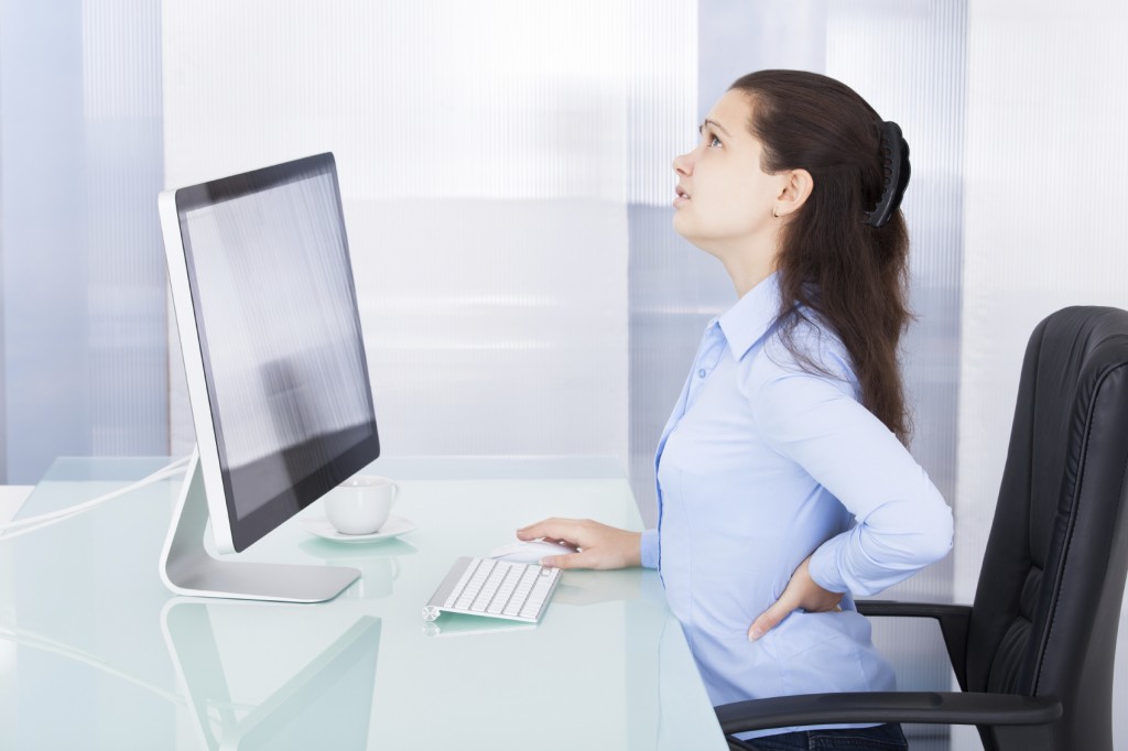 Portrait Of Young Businesswoman Suffering From Back Pain