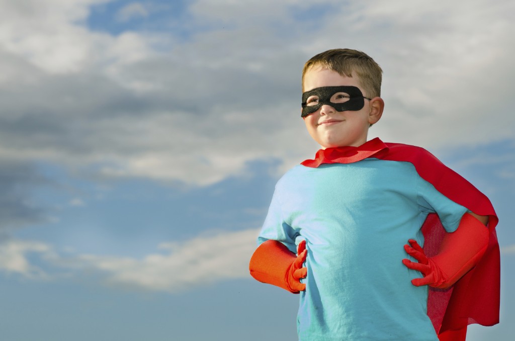 child pretending to be a superhero