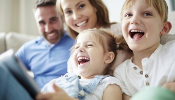 Children sitting together with parents and laughing